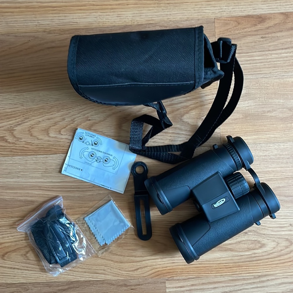 Binoculars with case, lens, cleaners, straps, and instructions